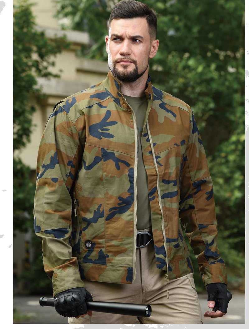 Model wearing tactical jacket in woodland camouflage